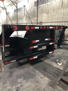 Kit for mounting a forklift on a step deck trailer.